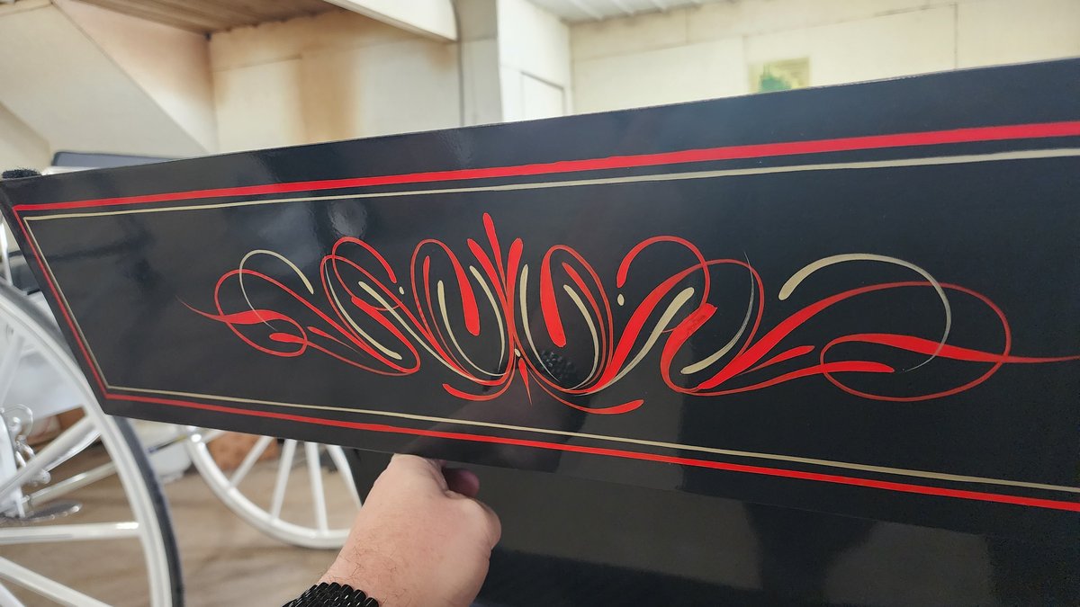 Elegant pinstriping scrollwork on carriage panel